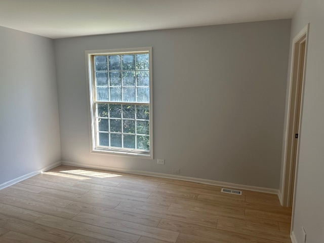 1311 Blue Ridge Parkway Algonquin, IL 60102 - Photo 14 of 21 a view of an empty room with wooden floor and a window