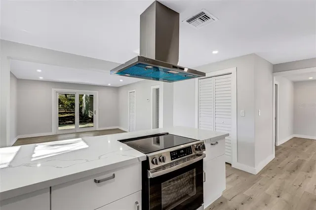 a kitchen with a stove a refrigerator and a sink