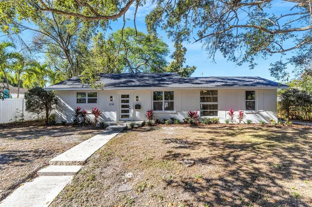 a view of a house with backyard sitting area and porch