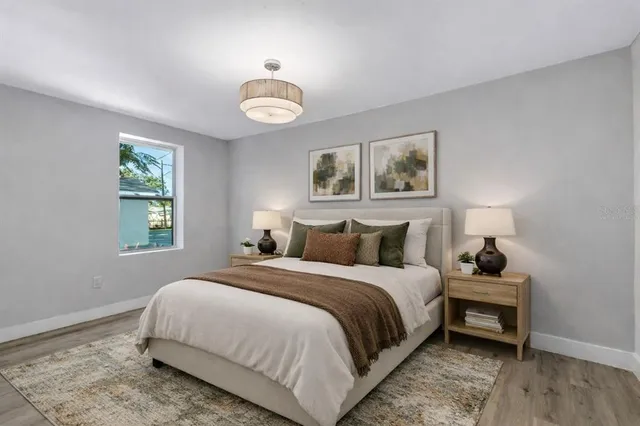 an empty room with wooden floor and white walls