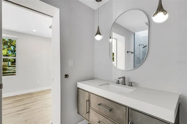 an empty room with wooden floor and white walls