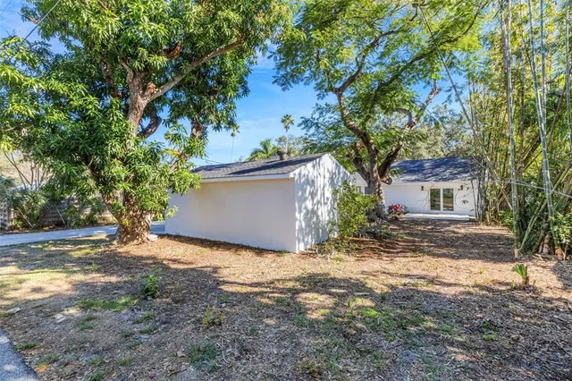 a view of backyard with outdoor seating a patio and plants