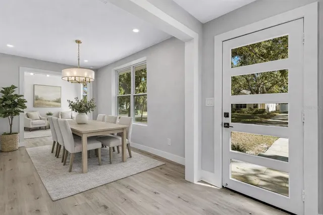 a kitchen with a stove and wooden floor