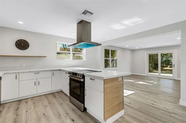 a kitchen with a stove and a window