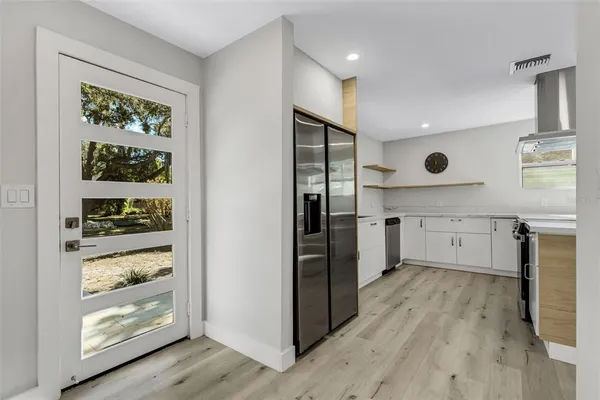 a kitchen with a sink and a refrigerator