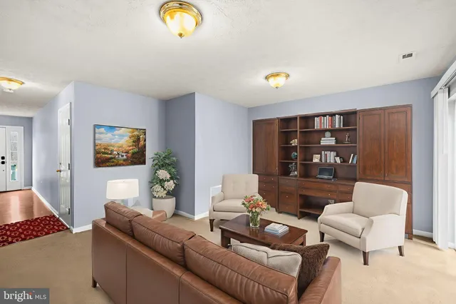 a living room with furniture a rug and a window