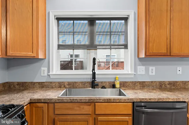 a view of a room with wooden floor and a ceiling fan