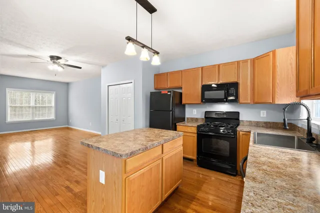 a bedroom with a large bed and a ceiling fan