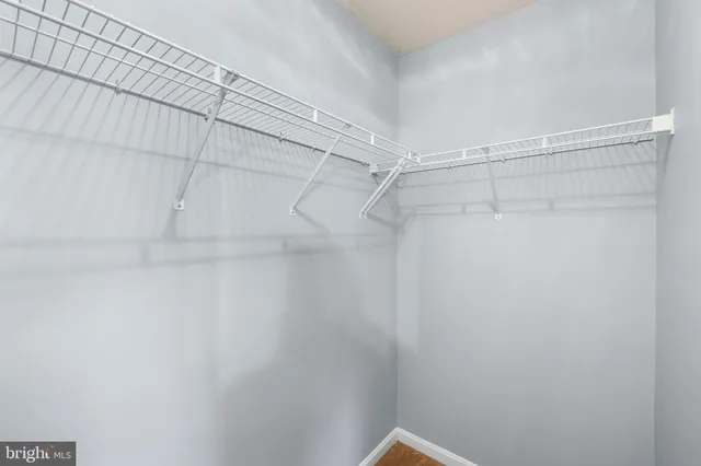 an empty room and chandelier fan