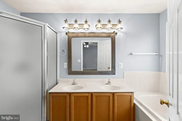 a bathroom with a toilet sink vanity and mirror