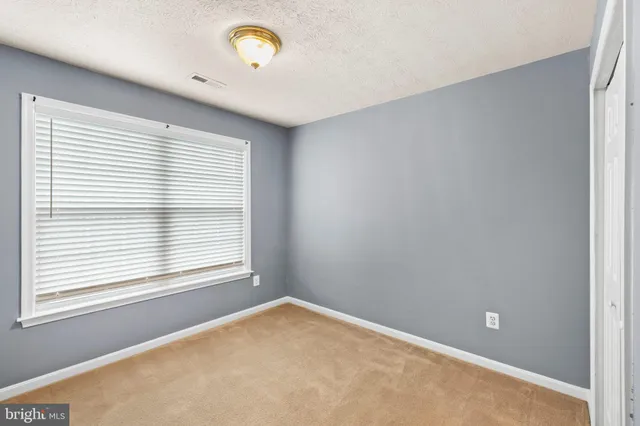 a picture of a bench in front of a wall