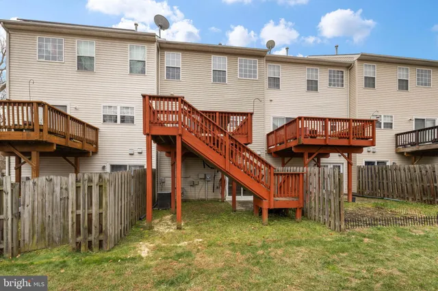 a view of a house with wooden fence