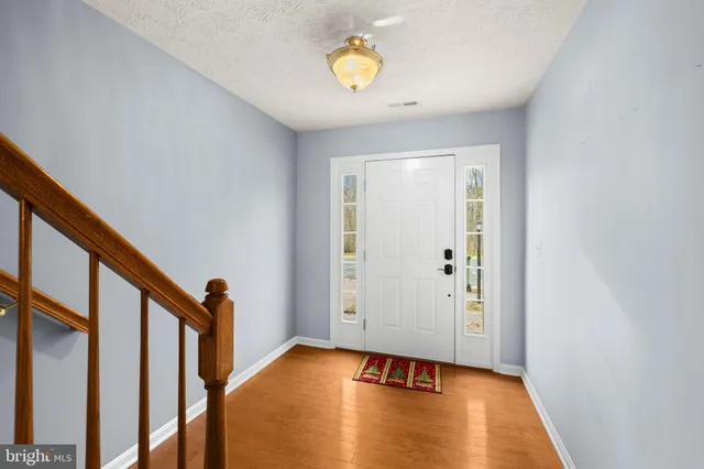 a view of an entryway with wooden floor