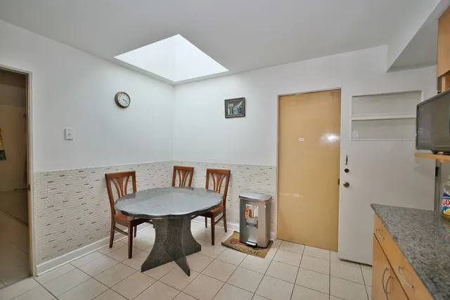 a view of a kitchen with furniture and wooden floor