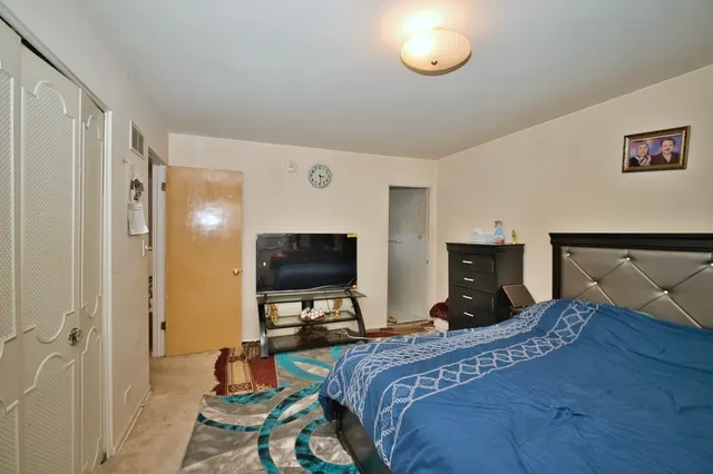 a bedroom with a bed and a television