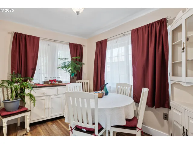 a dining room with furniture window and wooden floor