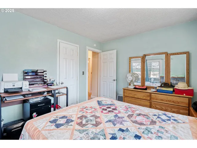 a bedroom with a bed and a large window
