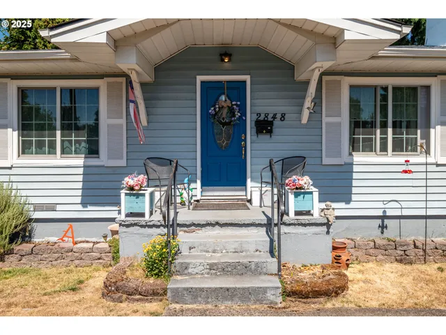 a view of a brick house with potted plants