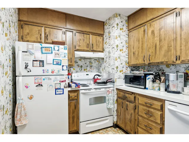 a kitchen with refrigerator and window