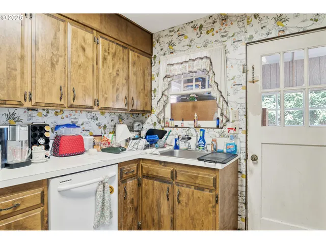 a kitchen with a sink a stove and cabinets
