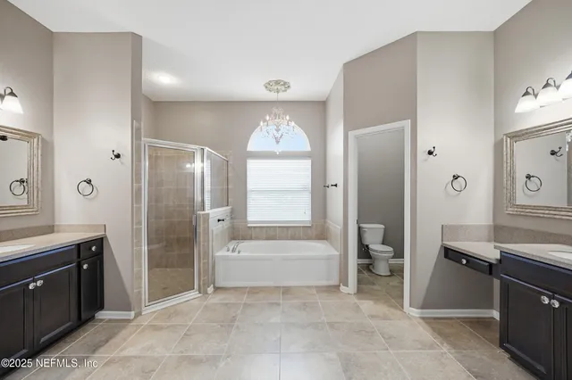 a spacious bathroom with a tub shower and sink