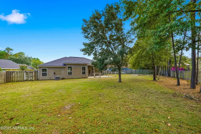 a view of a house with pool and tree s