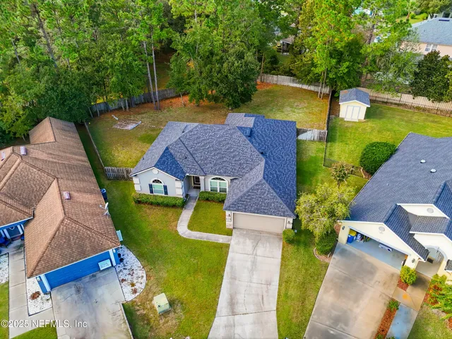 an aerial view of a house with a swimming pool