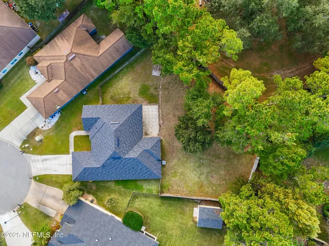 an aerial view of house with yard swimming pool and outdoor seating