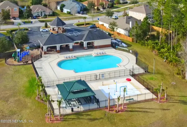 an aerial view of a house with a swimming pool yard and outdoor seating