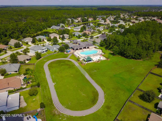 an aerial view of a house with a garden and outdoor seating