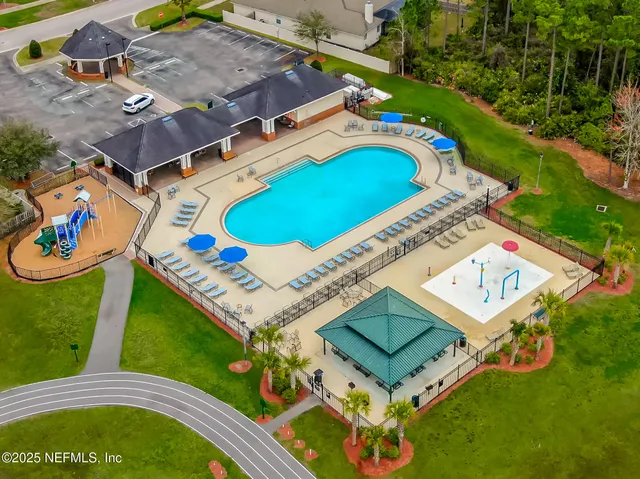 an aerial view of a house with a swimming pool