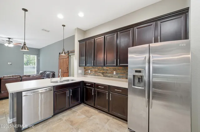 a kitchen with a sink stainless steel appliances and cabinets