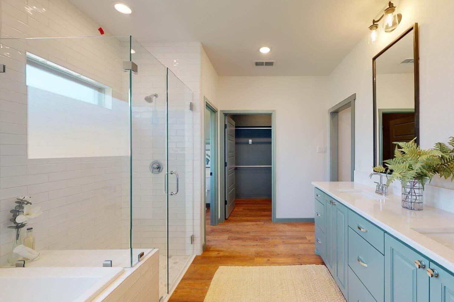 3617 128th Street Lubbock, TX 79423 - Photo 13 of 30 a spacious bathroom with a shower tub double sink and mirror