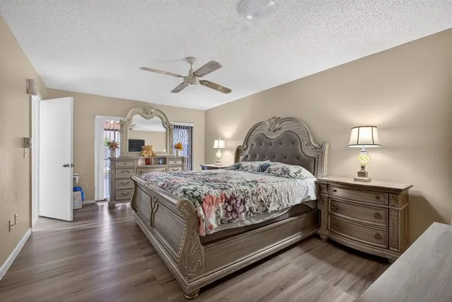 a spacious bedroom with a bed and a chandelier