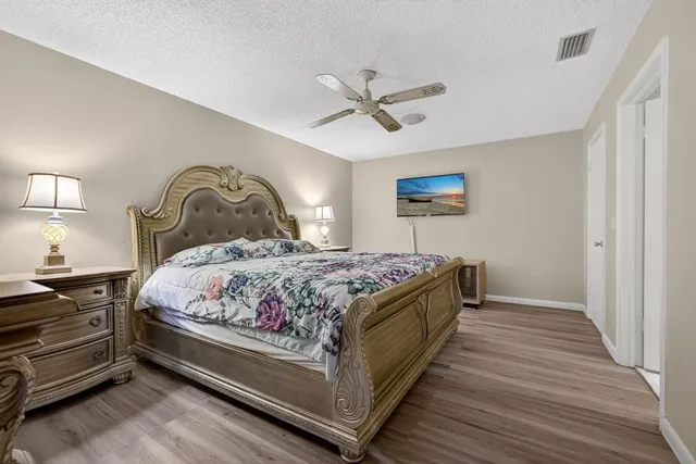 a bedroom with a bed and a painting on the wall