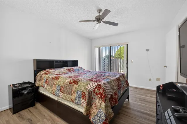 a bedroom with bed and wooden floor
