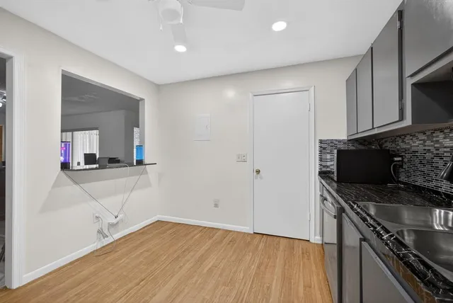 a kitchen with granite countertop a stove and a refrigerator