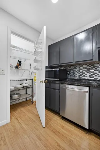 a kitchen with stainless steel appliances granite countertop a stove and a refrigerator