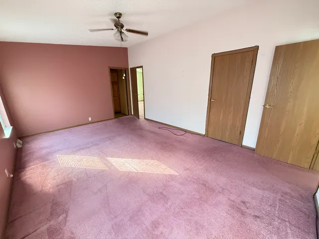 a kitchen with stainless steel appliances a stove a sink a refrigerator wooden floor and cabinets