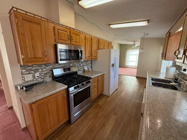 a bedroom with a bed and a ceiling fan