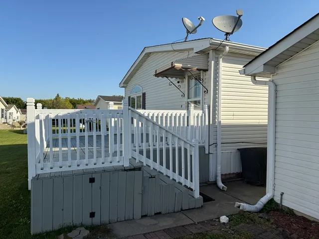 a view of wooden house with wooden fence