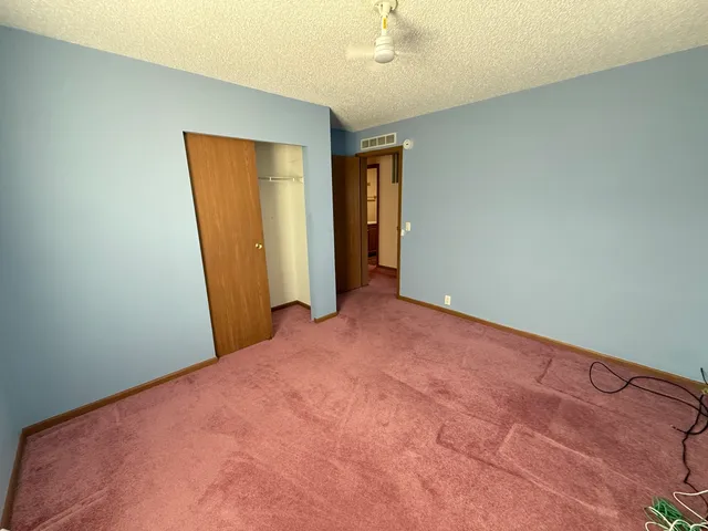 an empty room with closet area