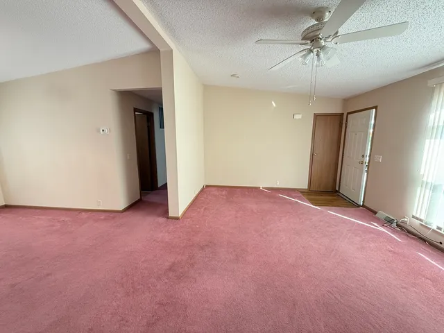 a view of a room with walk in closet and wooden floor