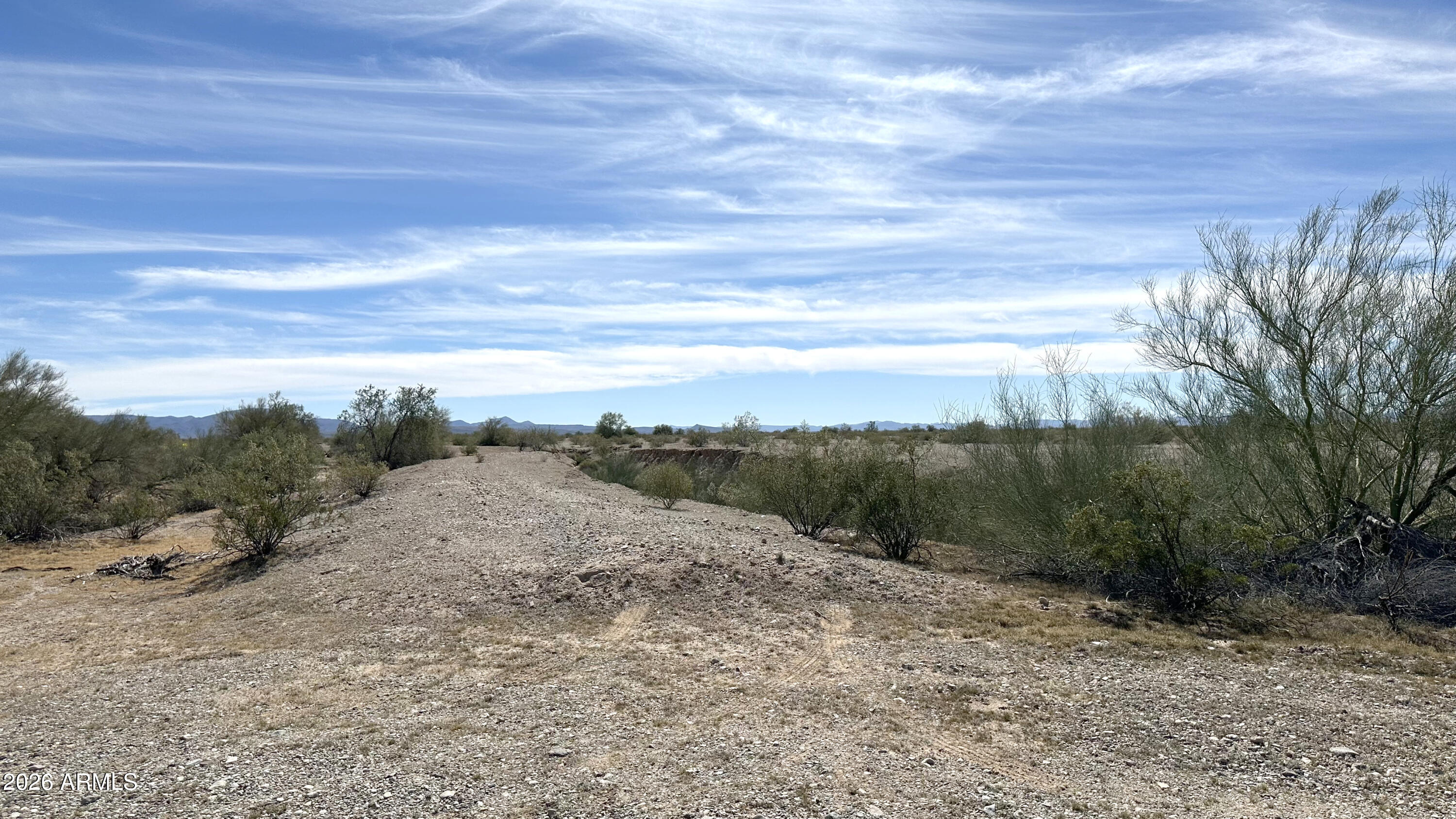 X West X W Adobe Ranch Gila Bend, AZ 85337 - Photo 2 of 12 a view of a dry yard with wooden fence