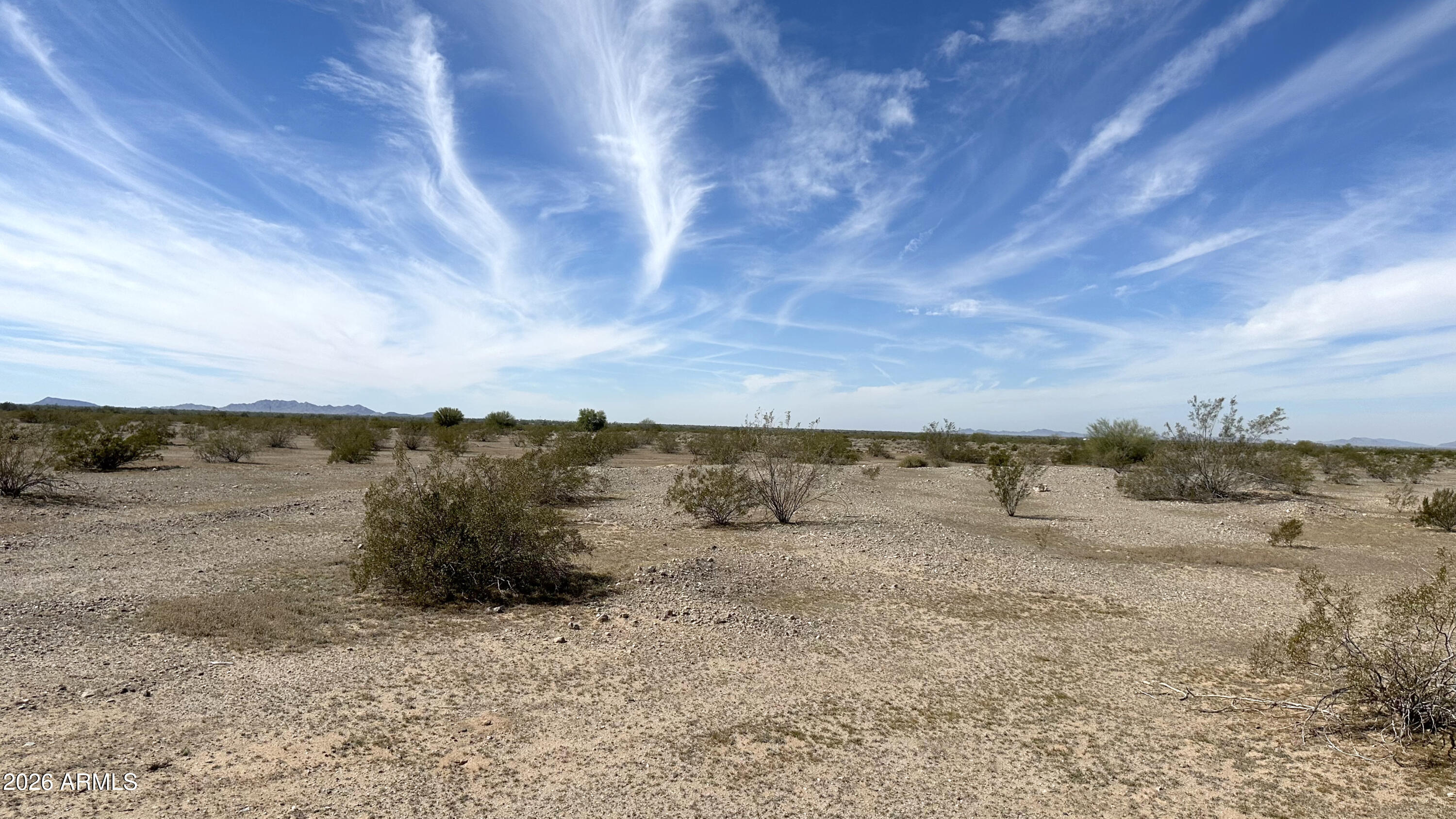 X West X W Adobe Ranch Gila Bend, AZ 85337 - Photo 7 of 12 a view of a dry yard with wooden fence