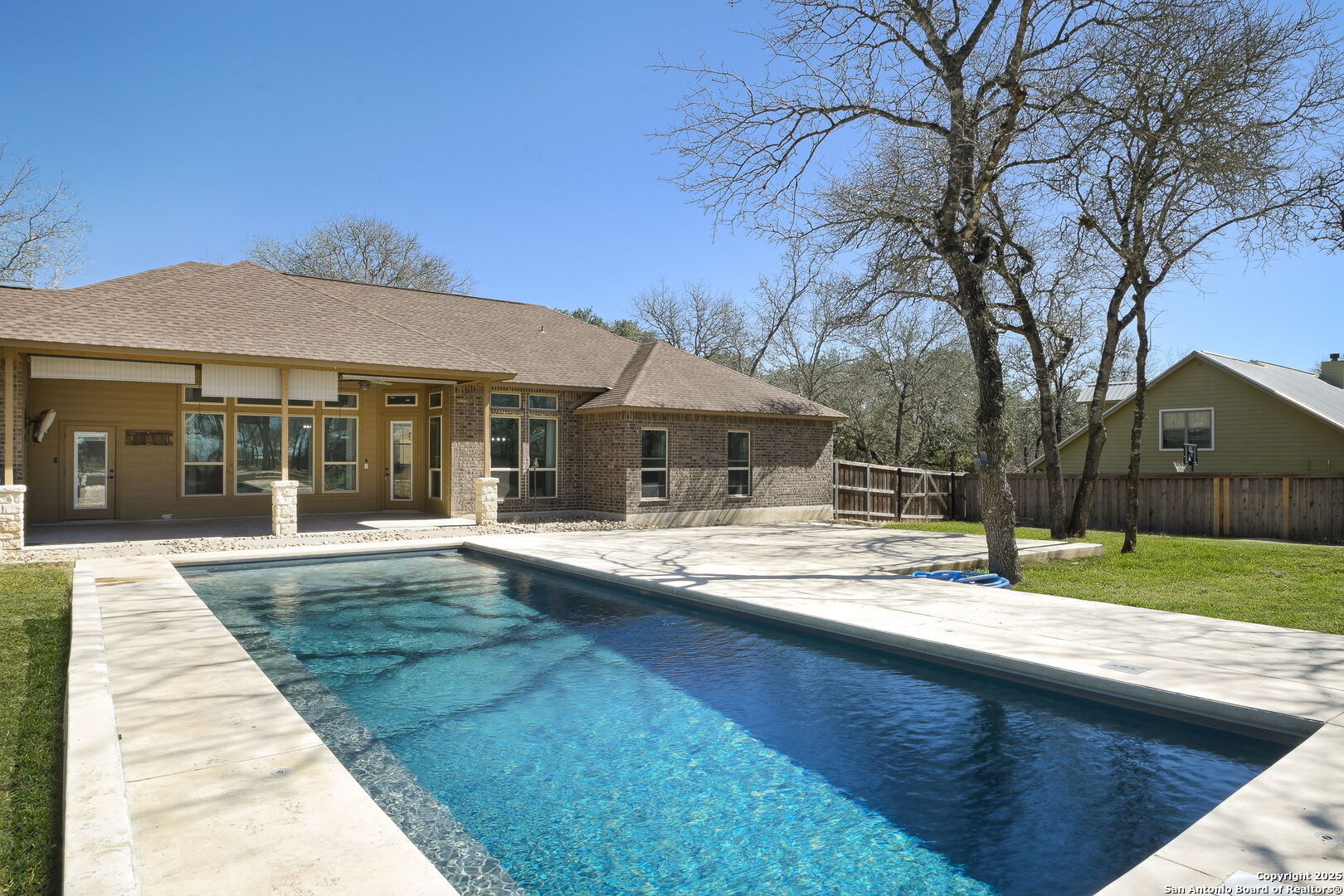 a view of house with yard and sitting area