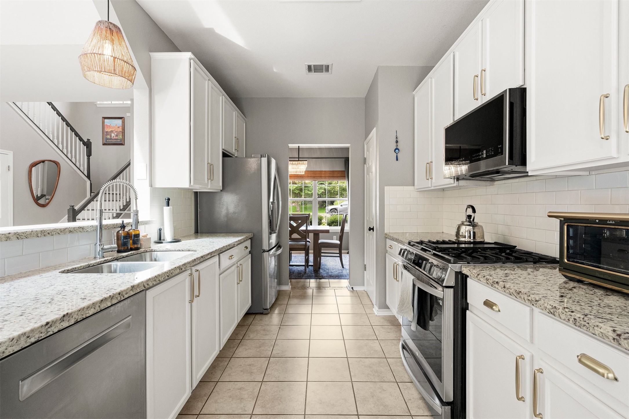 7009 Wandering Oak Road Austin, TX 78749 - Photo 2 of 36 Updated stainless steel appliances, abundant cabinetry, and broad countertops give home chefs the tools and space needed to whip up weeknight dinners or bake weekend treats