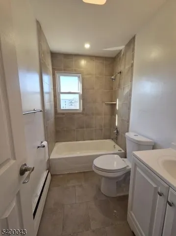 a bathroom with a granite countertop toilet a sink and bathtub