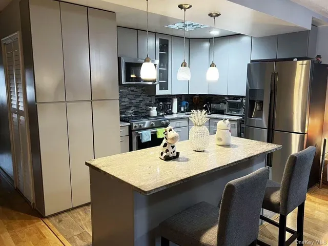 a kitchen with stainless steel appliances a sink and refrigerator