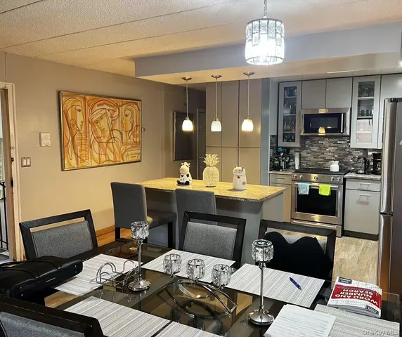 a view of a dining room with furniture and chandelier